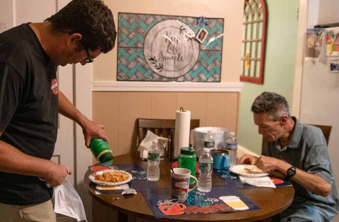 two men eating dinner at a table