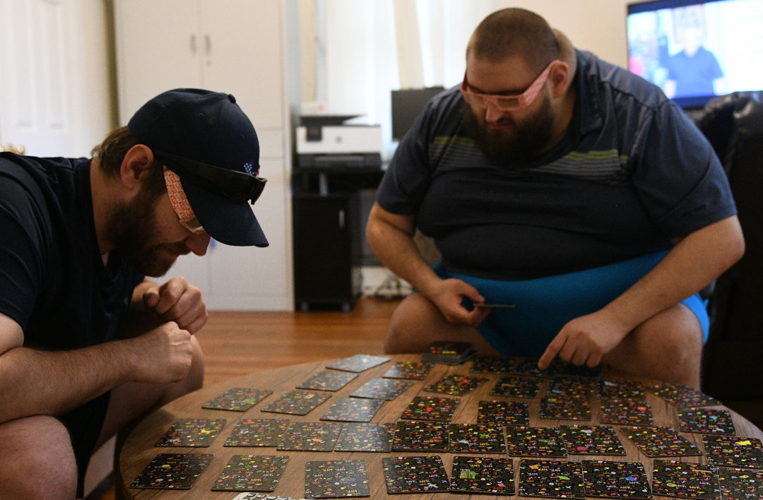 two men play a 3D card game