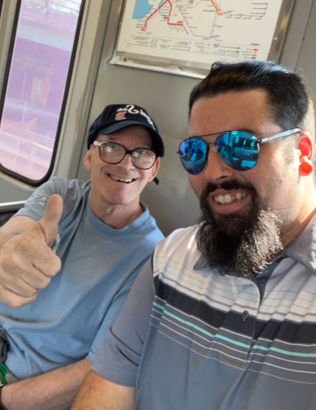 two men traveling on commuter train