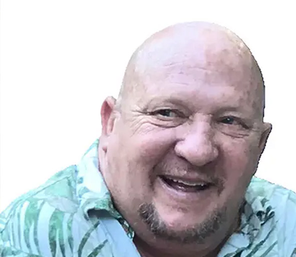 smiling man holding two pumpkins